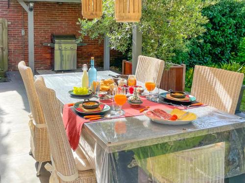 a table with plates of food and drinks on it at Villa Lucia in Rucphen
