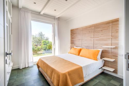 een slaapkamer met een groot bed en een groot raam bij Villa green Eden in Sorrento