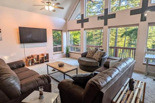 a living room with couches and a flat screen tv at Villa w/ Amazing Bay Views Near Beach w/ Garden, Ping Pong in Eastsound