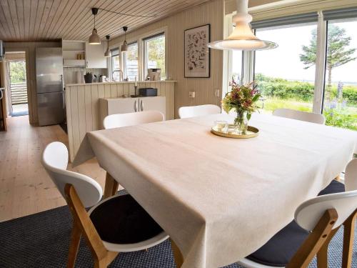a dining room with a white table and chairs at 6 person holiday home in Thyholm-By Traum in Thyholm