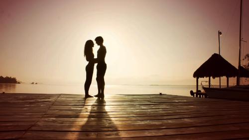 a couple standing on a pier looking at the water at Hotel Amainah Bacalar Adults Only in Bacalar