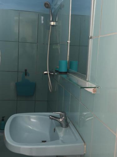 a bathroom with a sink and a mirror at villa NYL in Schœlcher