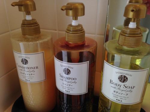 three bottles of soap sitting next to each other at Nozawa Grand Hotel in Nozawa Onsen