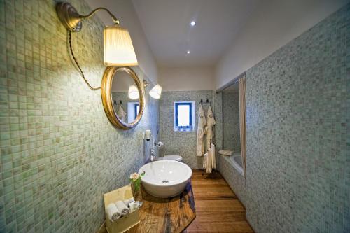 a bathroom with a sink and a mirror on the wall at B&B Le Dimore Mezza Costa in San Casciano in Val di Pesa