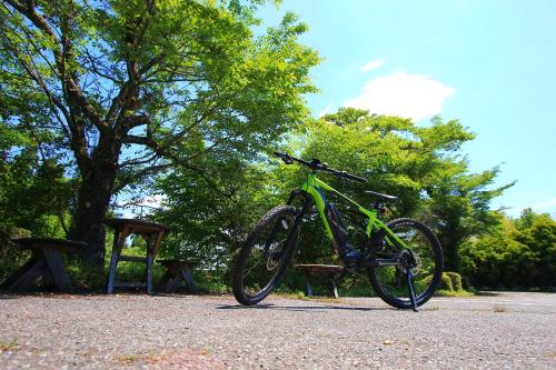 a bike parked on a bench in a park at Gokase Campsite Camping and Guesthouse in Gokase