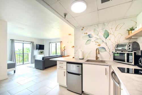 a kitchen with a sink and a microwave at Lovely Studio near Universal in Orlando