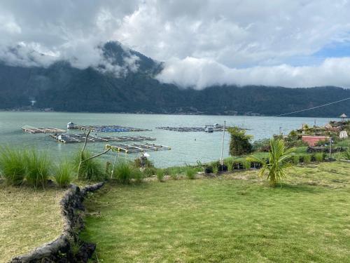 a view of a body of water with boats in it at D' Tepi Danau Glamping in Kintamani