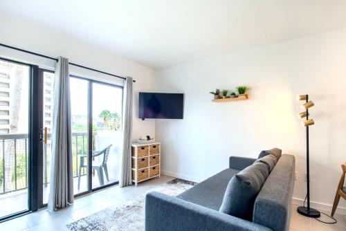 a living room with a couch and a tv at Studio near Universal Studios with great view in Orlando