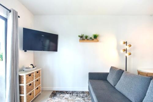 a living room with a couch and a flat screen tv at Studio near Universal Studios with great view in Orlando