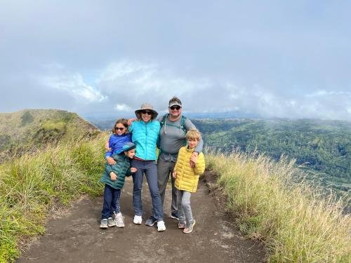 a family standing on a trail on a mountain at Batur Homestay and Lodge in Bangli