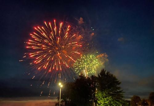 a group of fireworks in the night sky at Lakeshore Suites in North Bay