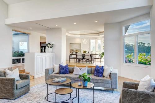 a living room with two couches and a table at Luxury Modern Chateau near wineries & beaches in Fallbrook
