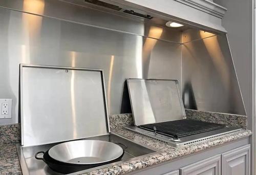 a laptop computer sitting on a counter in a kitchen at Luxury Modern Chateau near wineries & beaches in Fallbrook