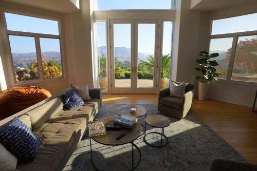 a living room with a couch and a table at Luxury Modern Chateau near wineries & beaches in Fallbrook