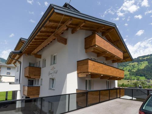 a building with wooden boxes on the side of it at Garni Nill in Schwendau