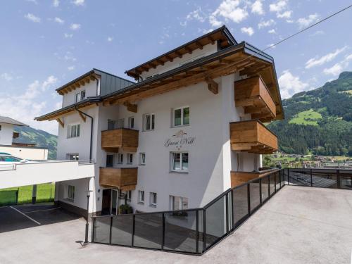 a house with a balcony with a view at Garni Nill in Schwendau