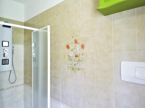 La salle de bains est pourvue d'une douche et d'une fresque murale aux fleurs. dans l'établissement Welcoming holiday home in Germignaga VA with garden, à Germignaga