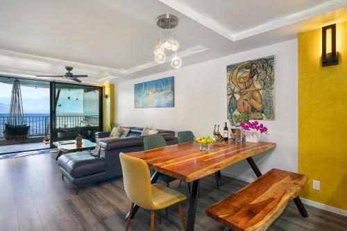 a living room with a table and a couch at Spectacular luxury , modern oceanfront condo Maalaea-Kihei ,Maui in Wailuku