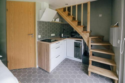 a small kitchen with a staircase in a room at Auksi puhkemaja-1 in Auksi