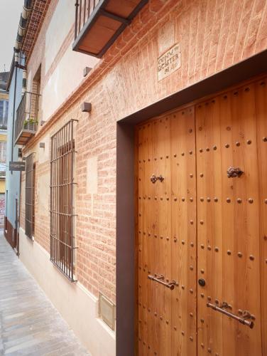 a wooden garage door in a brick building at LD Convento Cister in Málaga