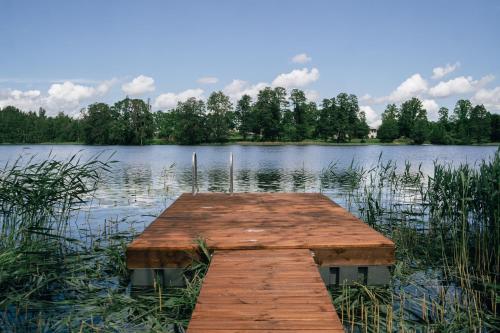 a wooden dock in the middle of a lake at Auksi puhkemaja-1 in Auksi