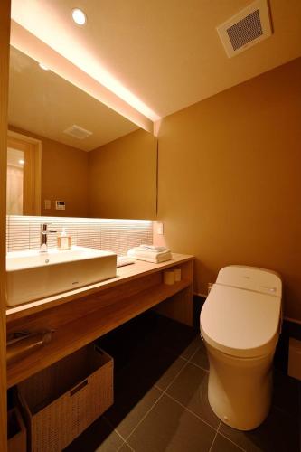 a bathroom with a white toilet and a sink at Kyoyado Heianshiki in Kyoto