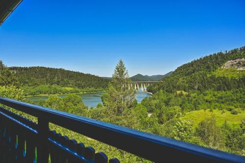 a view of a river with a bridge in the background at Casa Boho in Fužine