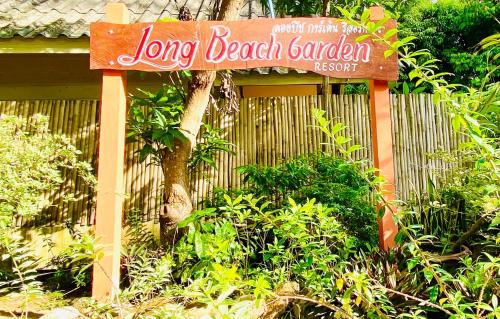 a sign for a long beach garden in front of a fence at Long Beach Garden Resort in Ko Lanta