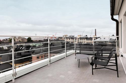 a balcony with two chairs and a table on a building at Lapland Hotels Bulevardi in Helsinki