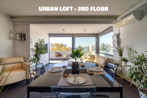 a living room with a table and a couch at Urban Loft & Urban Flat 2024 in Kavala