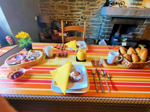 a table with a table cloth with food on it at Gouarec Bed & Breakfast in Gouarec