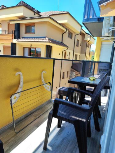 two tables and chairs on the balcony of a building at Spa Koncept-Apartmani in Veliko Gradište