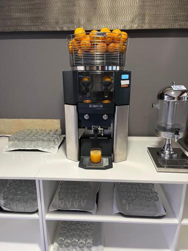 a coffee maker sitting on top of a shelf at Hotel Susuqui in Sanxenxo