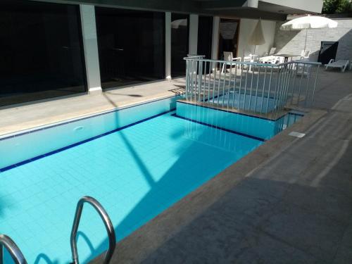 a swimming pool with a blue tile floor at Aura Home just 100 meters to Kleopatra Beach in Alanya