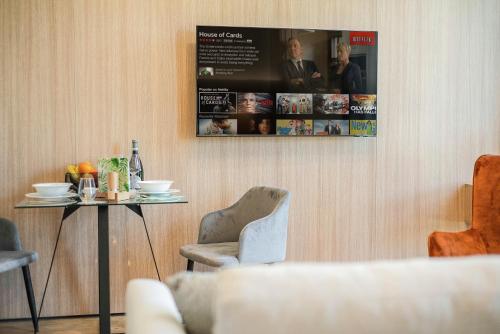 a room with a table and a picture on the wall at BRIGHT: Rosenheim Aicherpark in Rosenheim