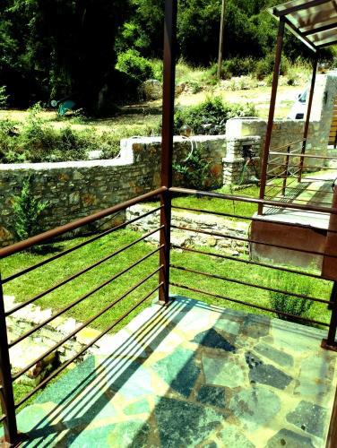a view of a porch with grass and stairs at ΕΚΑLI ROOMS APARTMENTS in Kalentzi