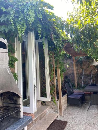 a patio with an open door and a grill at Nonno Paco Vacanze in Casarza Ligure
