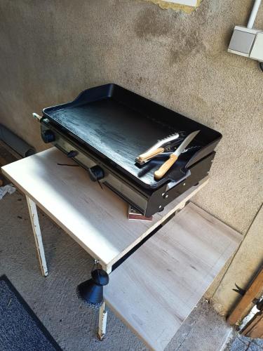 a briefcase with a knife in it on a table at Le Gite des Deux Lacs Settons in Planchez