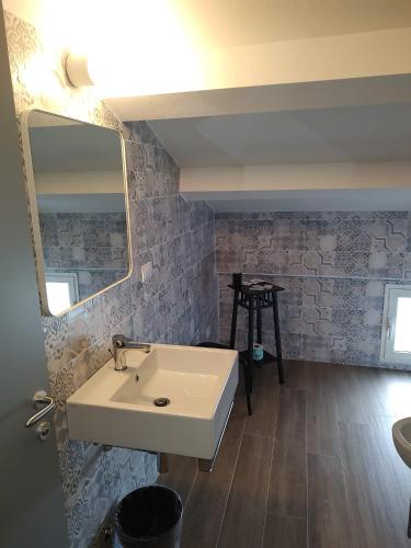 a bathroom with a white sink and a mirror at Hotel Alabama by ALEhotels in Rimini