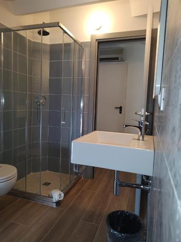 a bathroom with a shower and a sink and a toilet at Hotel Alabama by ALEhotels in Rimini