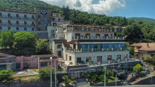 a large building with a clock tower in a city at Hotel Primavera Dell'Etna in Zafferana Etnea