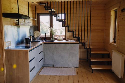 a kitchen with a counter and a staircase in a room at Бриндуш in Tatariv