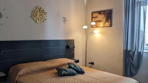 a bedroom with a bed with a headboard and a lamp at IL Castelletto in Ortona