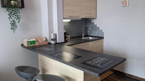 a kitchen with a black counter top and a sink at IL Castelletto in Ortona