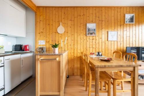 a kitchen with a table and chairs in a room at Center of Veysonnaz with a View ! in Veysonnaz