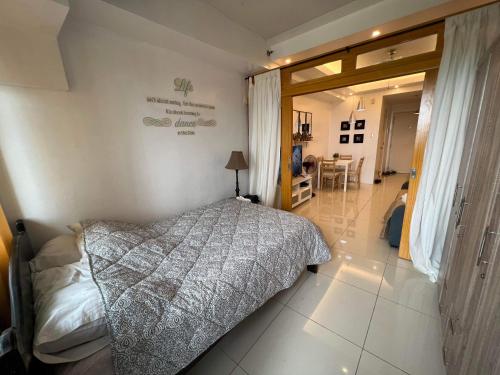 a bedroom with a bed and a dining room at Ron's Condo Overlooking the Lake in Tagaytay