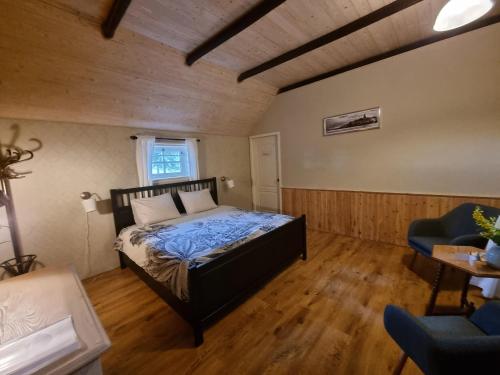 a bedroom with a bed and a table and a chair at B&B de Hugt in Ulrum