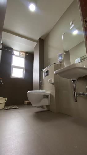 a bathroom with a sink and a toilet at Janeira in Shillong