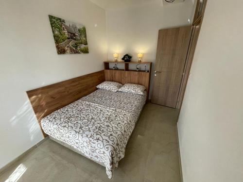 a small bedroom with a bed and a cabinet at Apartments Pericic in Sutomore