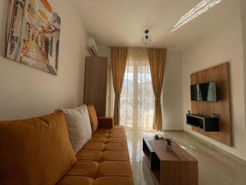 a living room with a couch and a table at Apartments Pericic in Sutomore